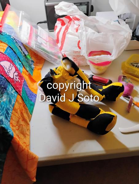 RABBIT B made with yellow and black material sewn together. Ears and tail made from Minky fabric. Wood joints installed for posing only. This is not a toy for children.