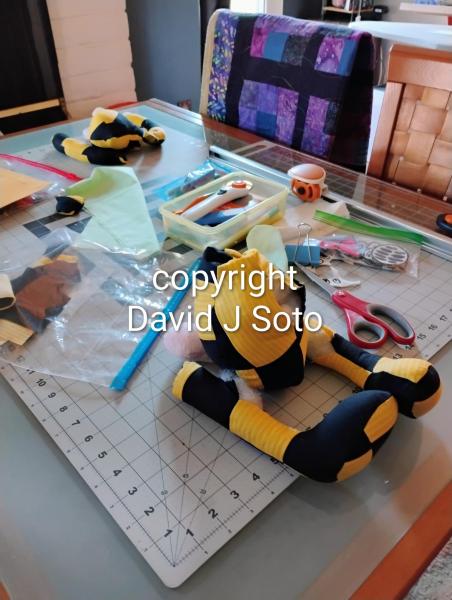 RABBIT B made with yellow and black material sewn together. Ears and tail made from Minky fabric. Wood joints installed for posing only. This is not a toy for children.